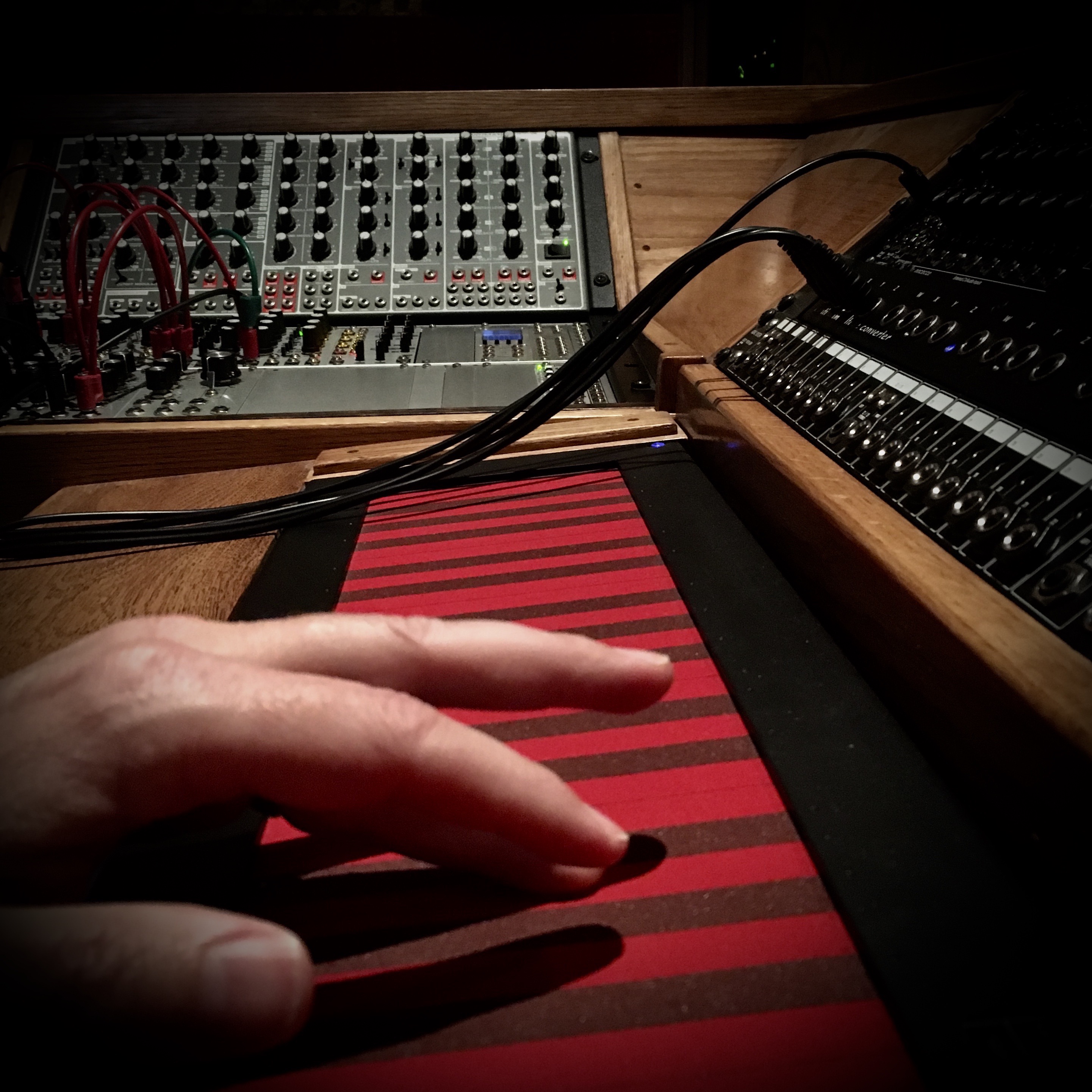 Hand interacting with a touch-sensitive musical controller.