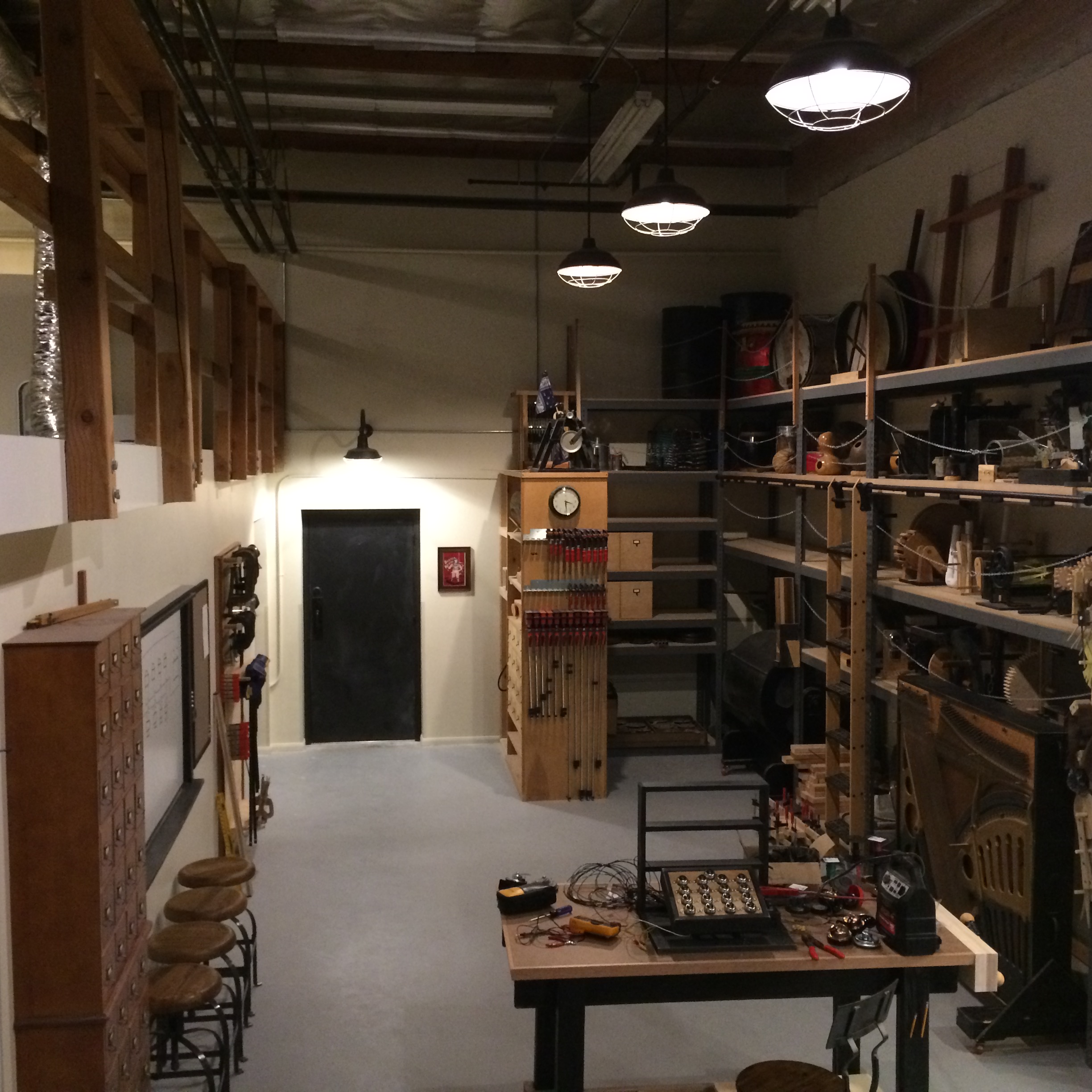 Sound Sculpture workshop interior with shelves of materials, tools, and custom-built instruments